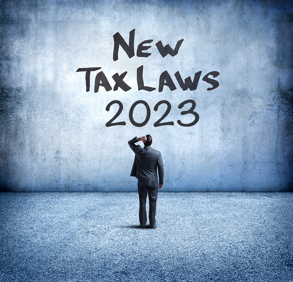 Man looking at sign on wall that says "New Tax Laws 2023"